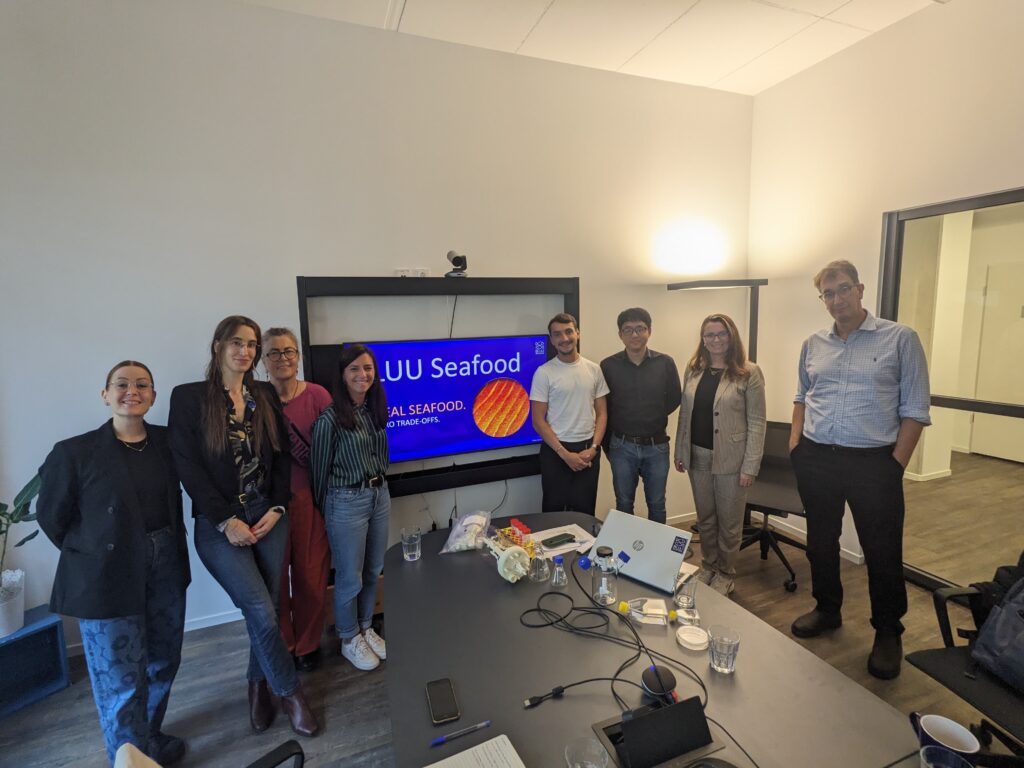 A group of eight people in a conference room